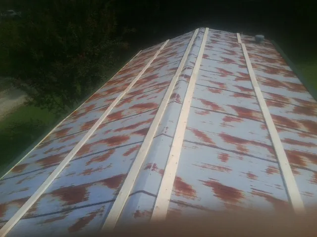 Rusted metal roof panels with new wood purlins before replacement — Storm Damage Roof Repair in Arendtsville by Roofing Brothers