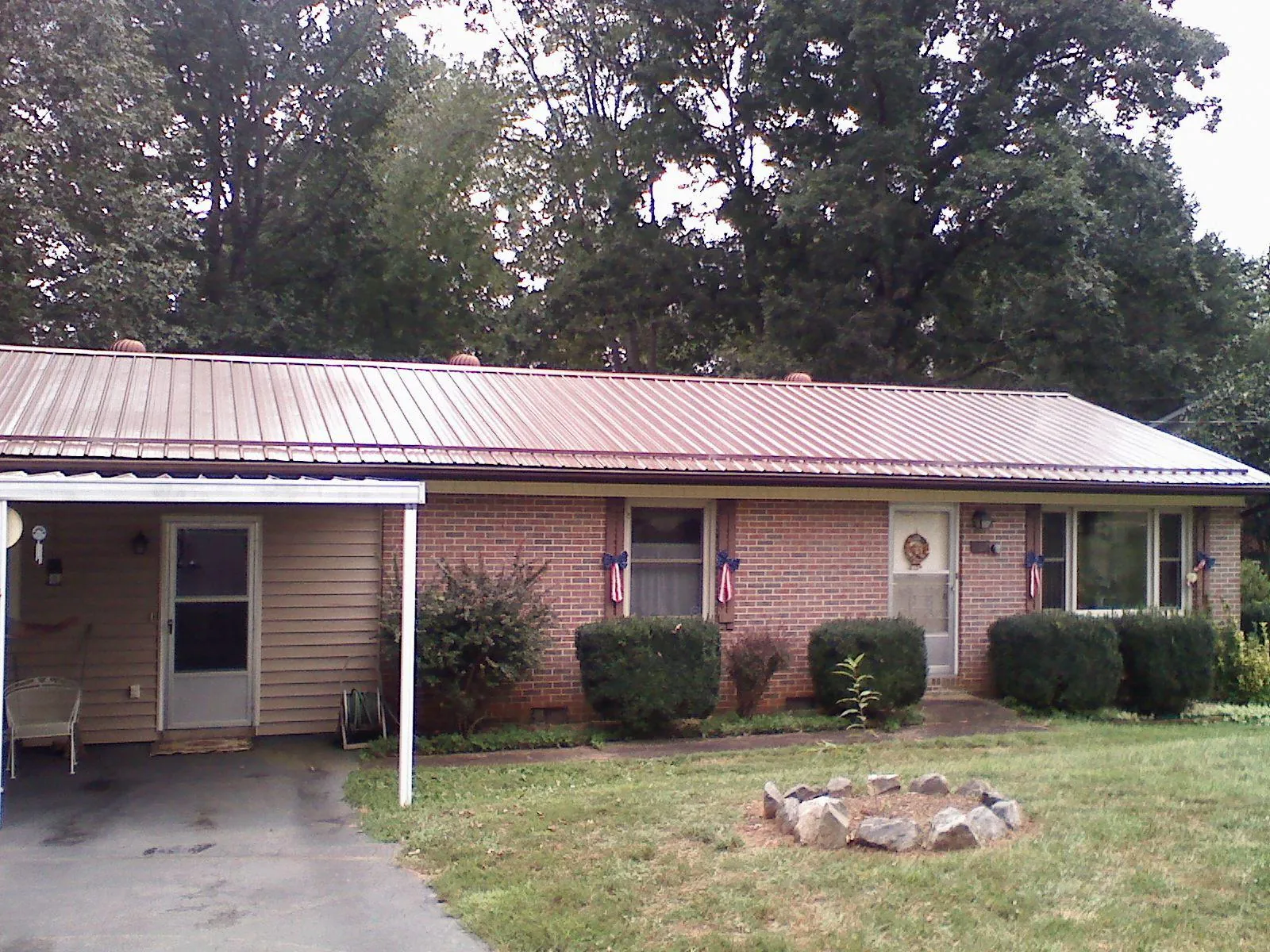 Bronze metal roof and carport on a brick ranch home — Roof Repair work by our crew in Arendtsville