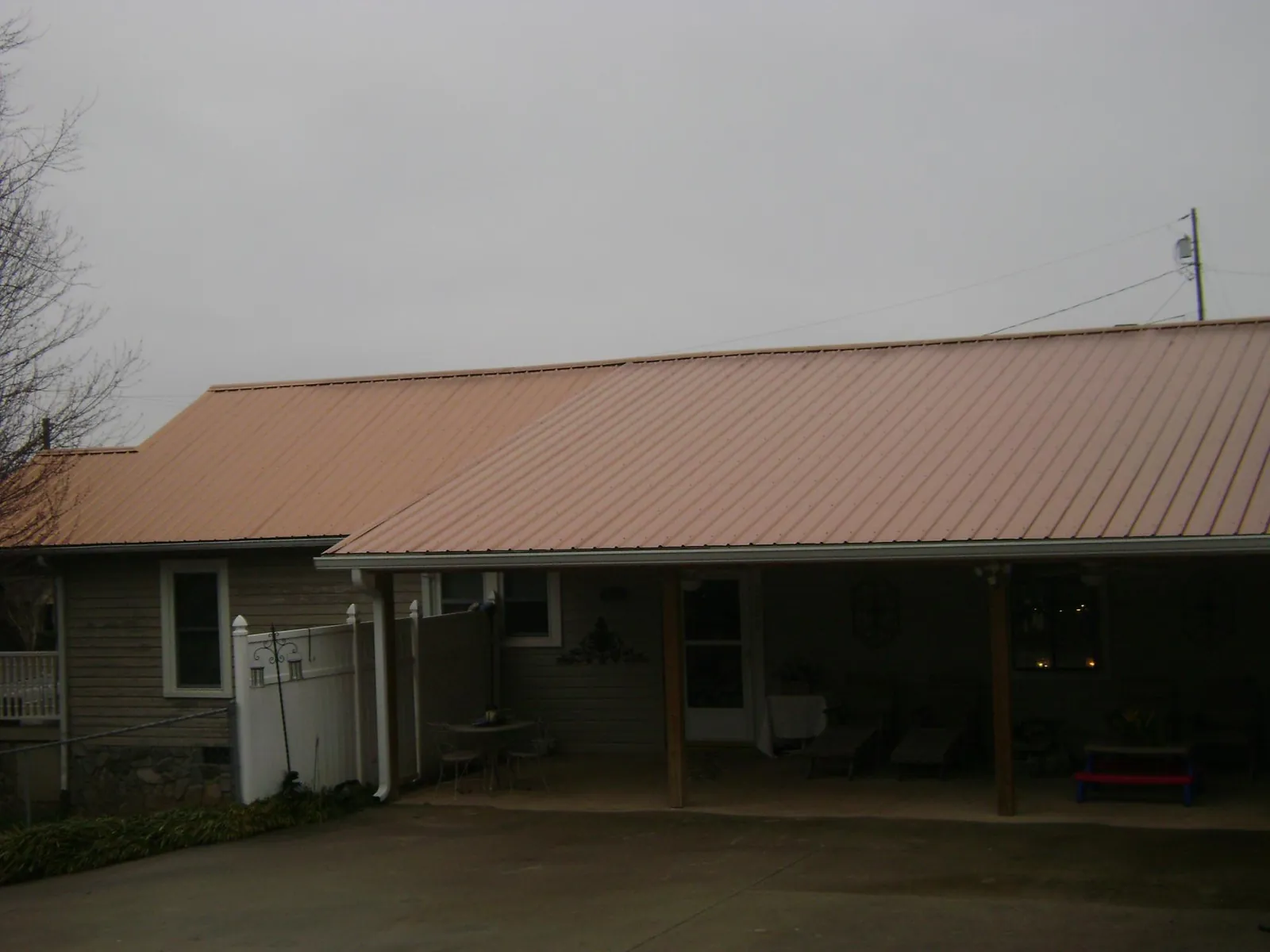 Copper toned metal roof over a wide covered patio in Arendtsville